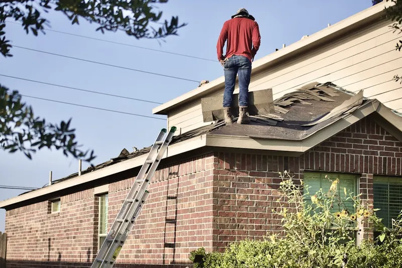 Professional roofer working on a residential roof in Medicine Lake
